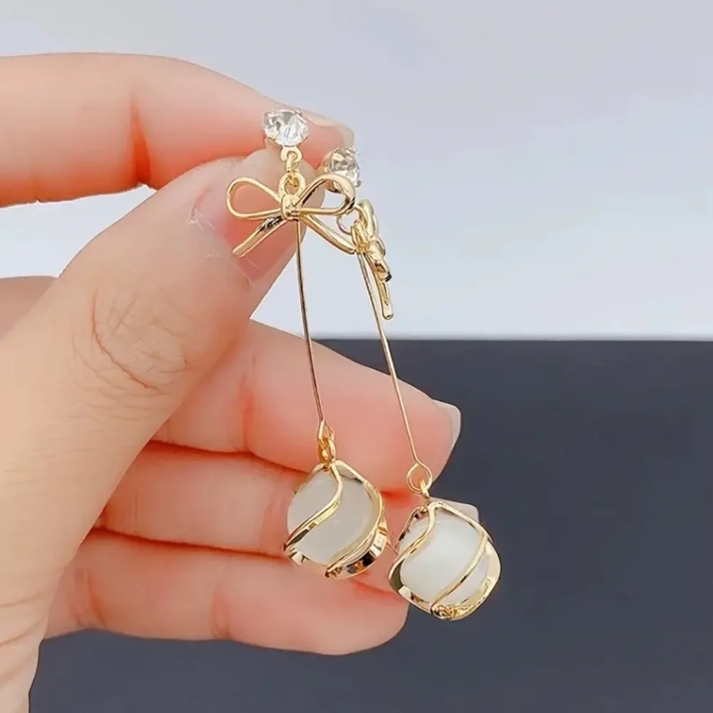Elegant Gold and White Drop Earrings. Christmas ball and bow earrings.